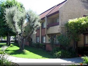 Azusa apartment for rent - A building with a red roof and a green lawn in front.
