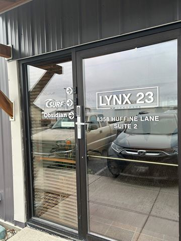 Bozeman apartment for rent - A glass door with a sign that says Lynx 23.