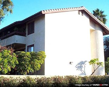 Costa Mesa apartment for rent - a white house with a balcony and trees