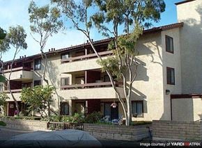 Costa Mesa apartment for rent - a large white building with trees in front of it
