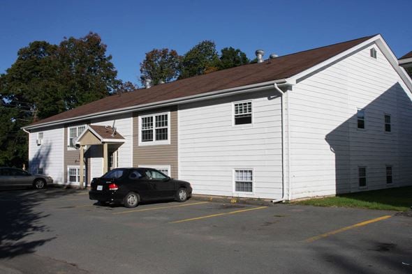 Berwick apartment for rent - A white building with a black car parked in front.