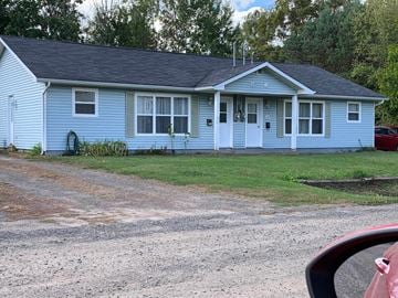 Kentville apartment for rent - A blue house with a red car parked in front.