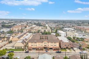 Hawthorne apartment for rent - A large building with a parking lot in front of it.