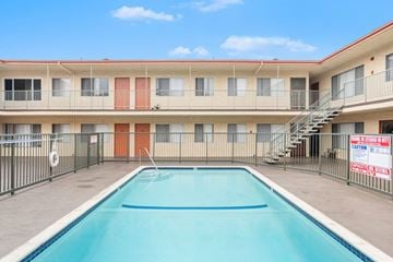 Hawthorne apartment for rent - A swimming pool in front of a multi-story apartment building.