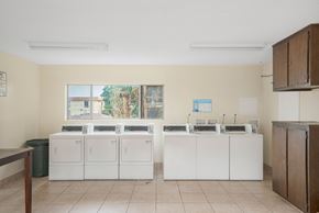 Hawthorne apartment for rent - A room with a row of sinks and a window.