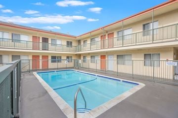 Hawthorne apartment for rent - A swimming pool in a courtyard surrounded by apartment buildings.