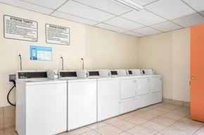 Hawthorne apartment for rent - A row of sinks are lined up in a room with a sign on the wall.
