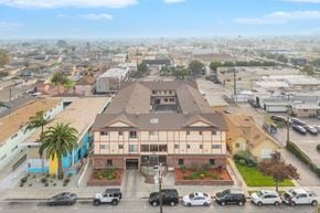 Hawthorne apartment for rent - A building with the number 4380 on it is surrounded by cars and palm trees.