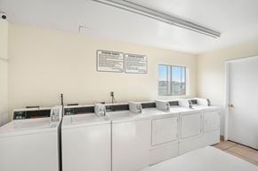 Hawthorne apartment for rent - A row of washing machines are in a laundromat.