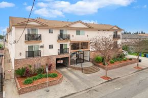 Hawthorne apartment for rent - A large apartment building with a courtyard in front.