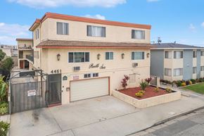 Hawthorne apartment for rent - A two-story building with a garage and a driveway in front.