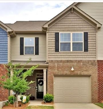 Indian Land house for rent - A house with a grey garage door and a brick wall.
