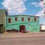 Philadelphia apartment for rent - A green building with red shutters is in the foreground.