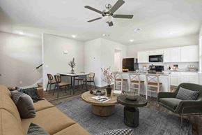 Leander apartment for rent - A living room with a couch, chairs, and a dining table.