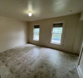 Cleveland apartment for rent - A room with a light on and two windows.