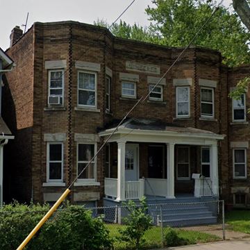 Cleveland apartment for rent - A brown brick house with a white porch.