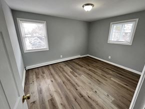 Washington apartment for rent - A room with wooden flooring and two windows.