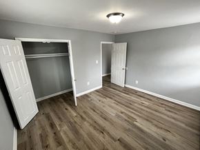Washington apartment for rent - A room with wood flooring and two white doors.
