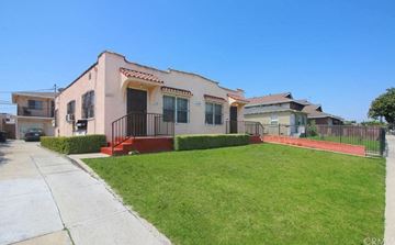 Los Angeles apartment for rent - A house with a red fence and a green lawn.