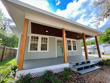 St. Augustine apartment for rent - A house with a grey exterior and a wooden porch.