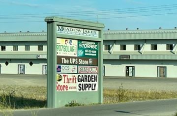 Wasilla apartment for rent - A sign for Meadow Jakes is in front of a building.