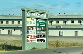 Wasilla apartment for rent - A sign for Meadow Jakes is in front of a building.