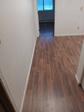 Wasilla apartment for rent - A hallway with wood floors and white walls.
