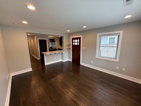 Charlotte house for rent - A room with wooden floors and a white wall.