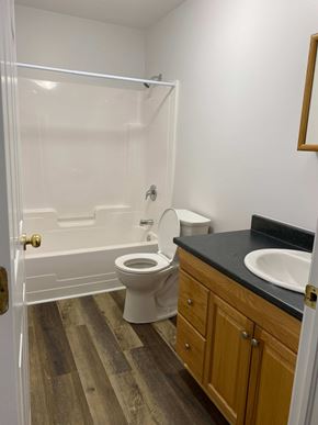 Kentville apartment for rent - A white toilet sits in a bathroom next to a sink.