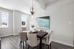 London apartment for rent - A dining room with a table set for two and a painting on the wall.