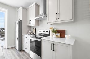 London apartment for rent - A modern kitchen with white cabinets and appliances.