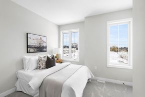 London apartment for rent - A bedroom with a large bed and a window showing a snowy landscape outside.