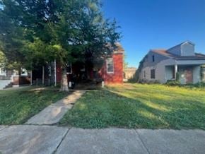 St. Louis apartment for rent - A house with a red door is surrounded by trees.