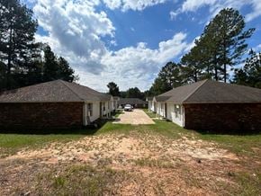 Purvis apartment for rent - A row of houses with a dirt path between them.