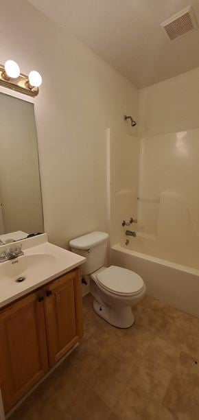 Purvis apartment for rent - A white toilet sits in a bathroom next to a sink.