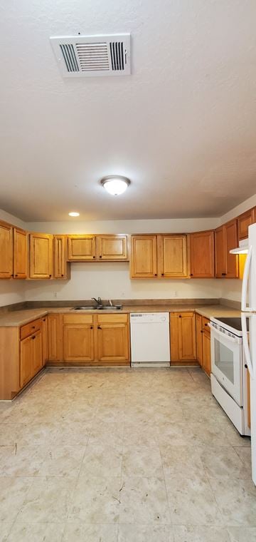 Purvis apartment for rent - A kitchen with wooden cabinets and white appliances.