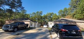 Purvis apartment for rent - A black SUV is parked in front of a house.