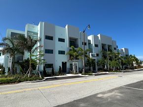 Pompano Beach apartment for rent - A white building with the words "LEXUS" on the side.