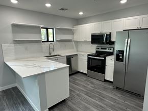 Pompano Beach apartment for rent - A kitchen with white cabinets and a white counter top.