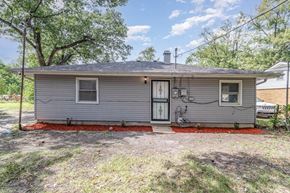 Gary house for rent - A small grey house with a red border around the foundation.