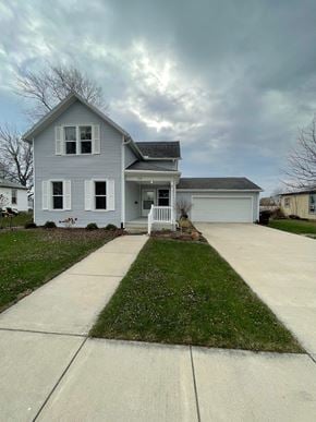 Elida house for rent - A grey house with a white garage door and a small front yard.
