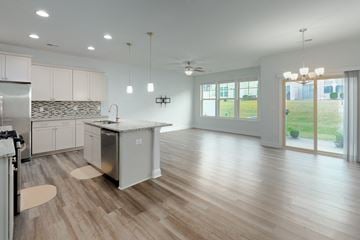 Durham house for rent - A modern kitchen with wooden floors and a large island.
