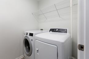 Durham house for rent - A washing machine and dryer in a small laundry room.