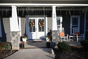 Garner house for rent - A house entrance with a white door and two chairs.