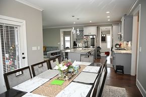 Garner house for rent - A kitchen with a table set for four with a green napkin on it.