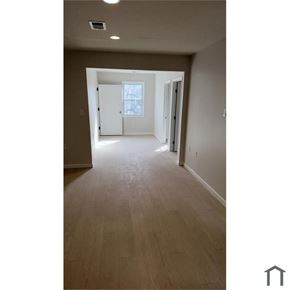 Washington apartment for rent - A long hallway with a white door at the end.