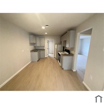Washington apartment for rent - A kitchen area with white appliances and wooden floors.