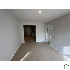Washington apartment for rent - A room with a white wall and a brown door.