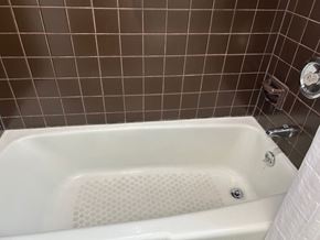 Oak Park apartment for rent - A white bathtub with a shower head and faucet.