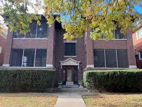 Oak Park apartment for rent - A red brick building with a black door and windows.